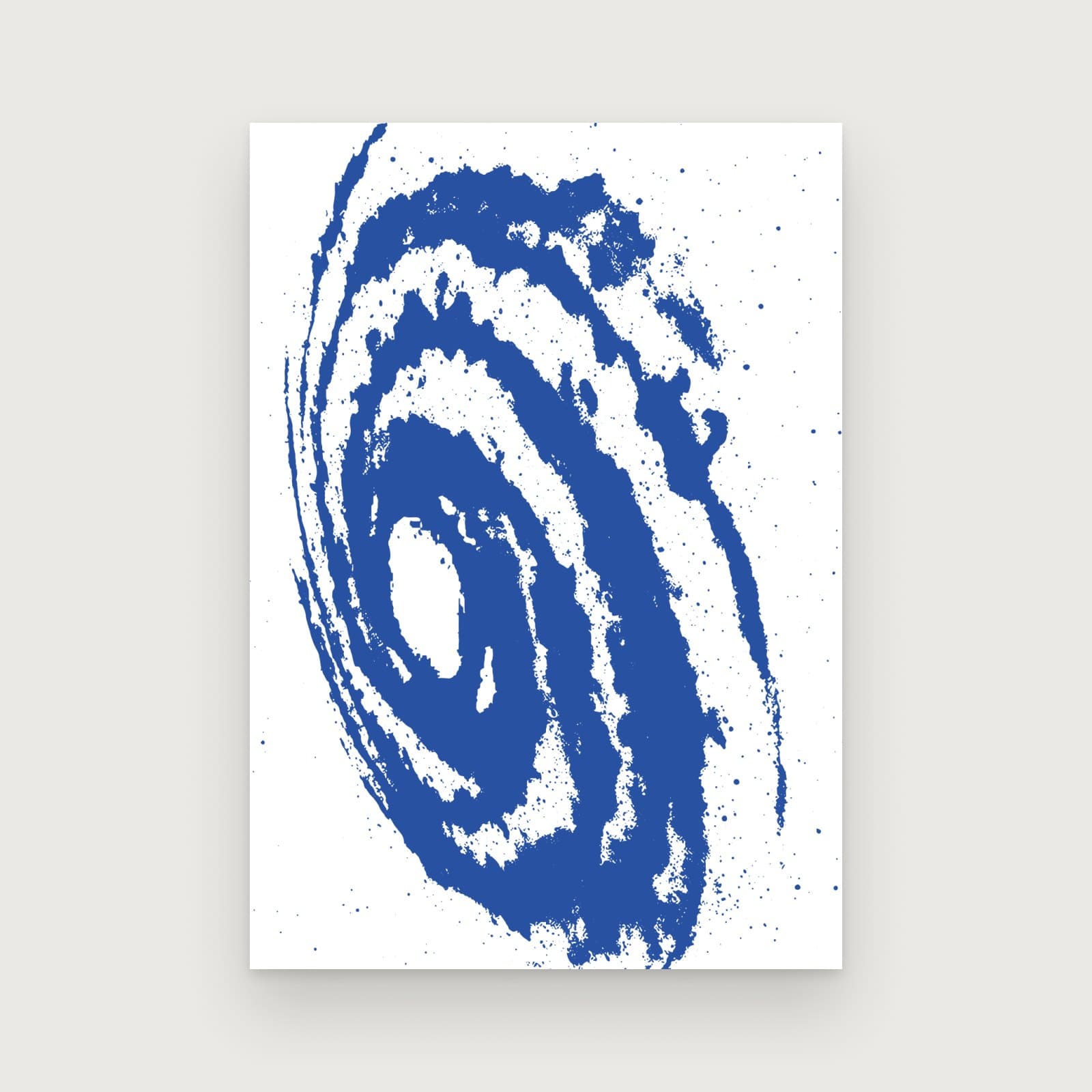 An organic print: a blue galaxy spiral breaking into grain on white